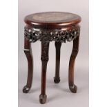 A 19th century Chinese hardwood and marble inset urn stand, of oval outline, the apron pierced and