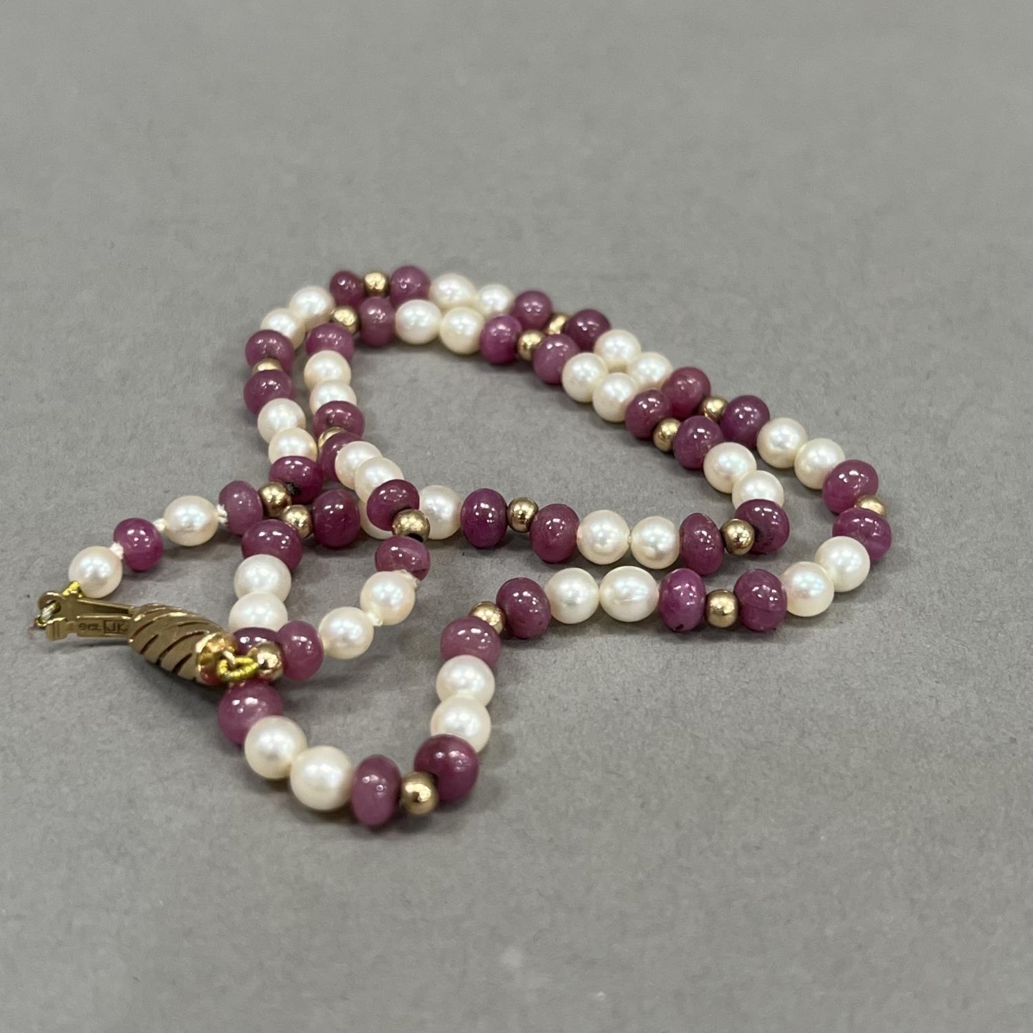 A seed pearl and ruby bead necklace, the approximate 4.5mm diameter spherical ruby beads interspaced - Image 2 of 2