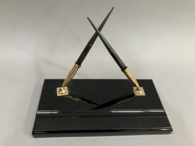 A Sheaffer's black and gilt metal desk standish with two fountain pens, each fitted with a 14K