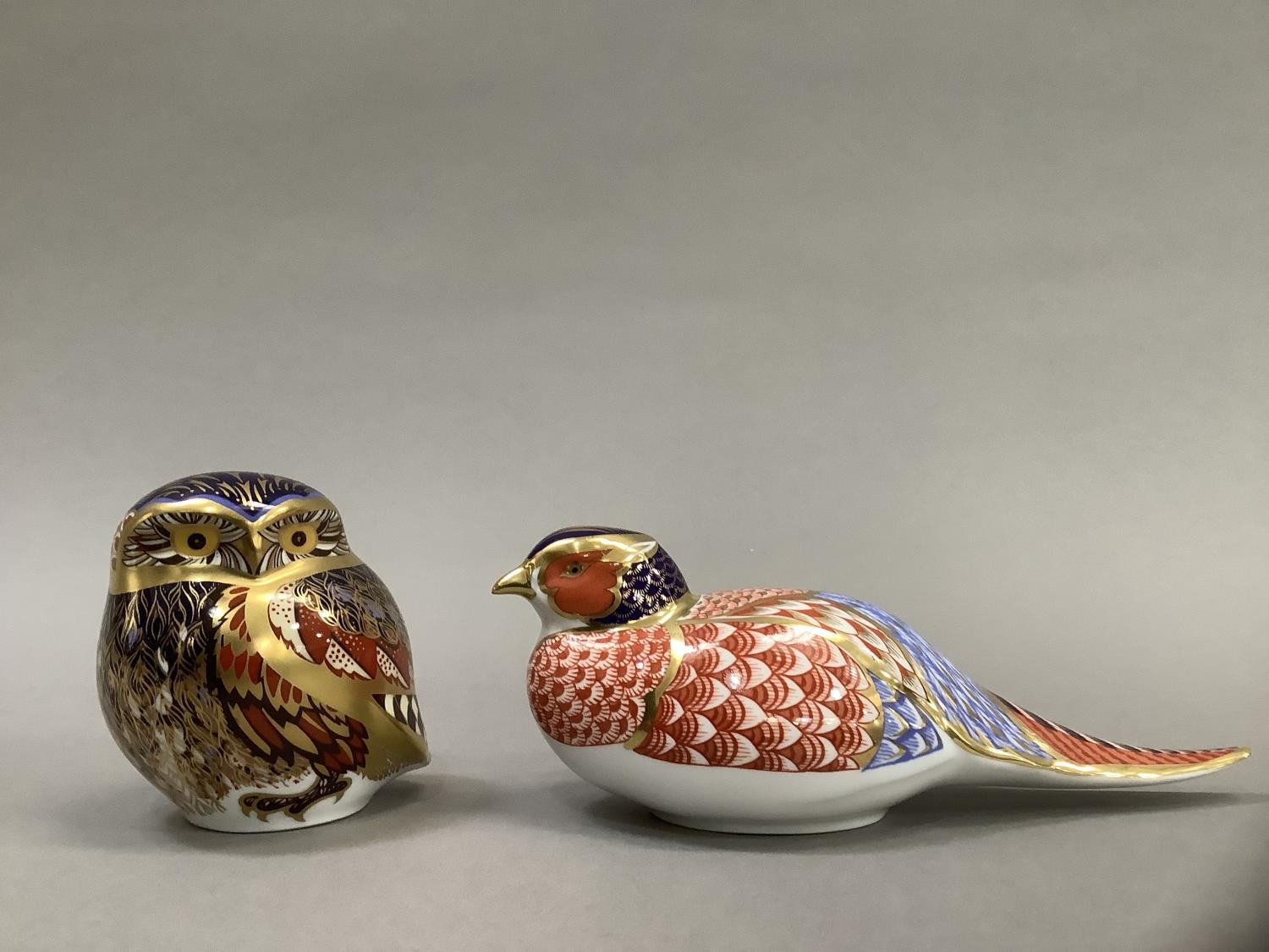 A Royal Crown Derby owl and pheasant paperweight, gold button to one, 8cm and 6.5cm high
