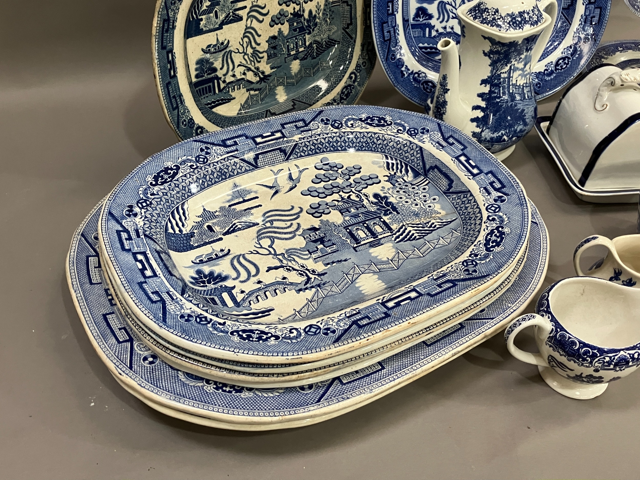 A collection of blue and white ware comprising several willow pattern meat plates, willow pattern - Image 2 of 4