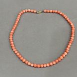 A necklace of spherical coral beads, each approximate 6mm diameter fastened with 9ct gold snap,