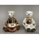 A Royal Crown Derby alphabet bear, gold button, together with drummer bear, 10.5cm and 10cm high