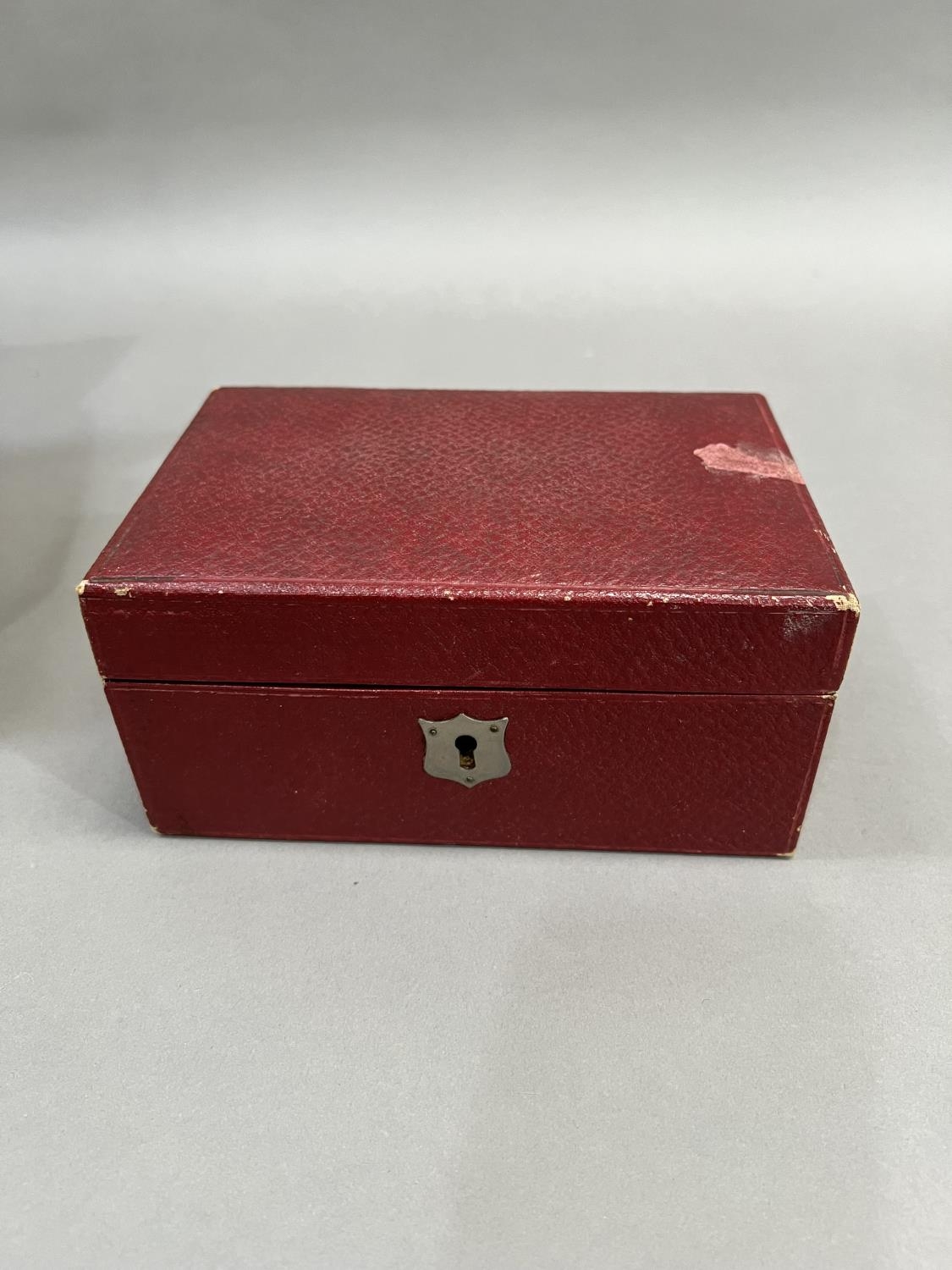AN early 20th century jewellery case covered in faux red leather with tiered red velvet lining - Image 3 of 3