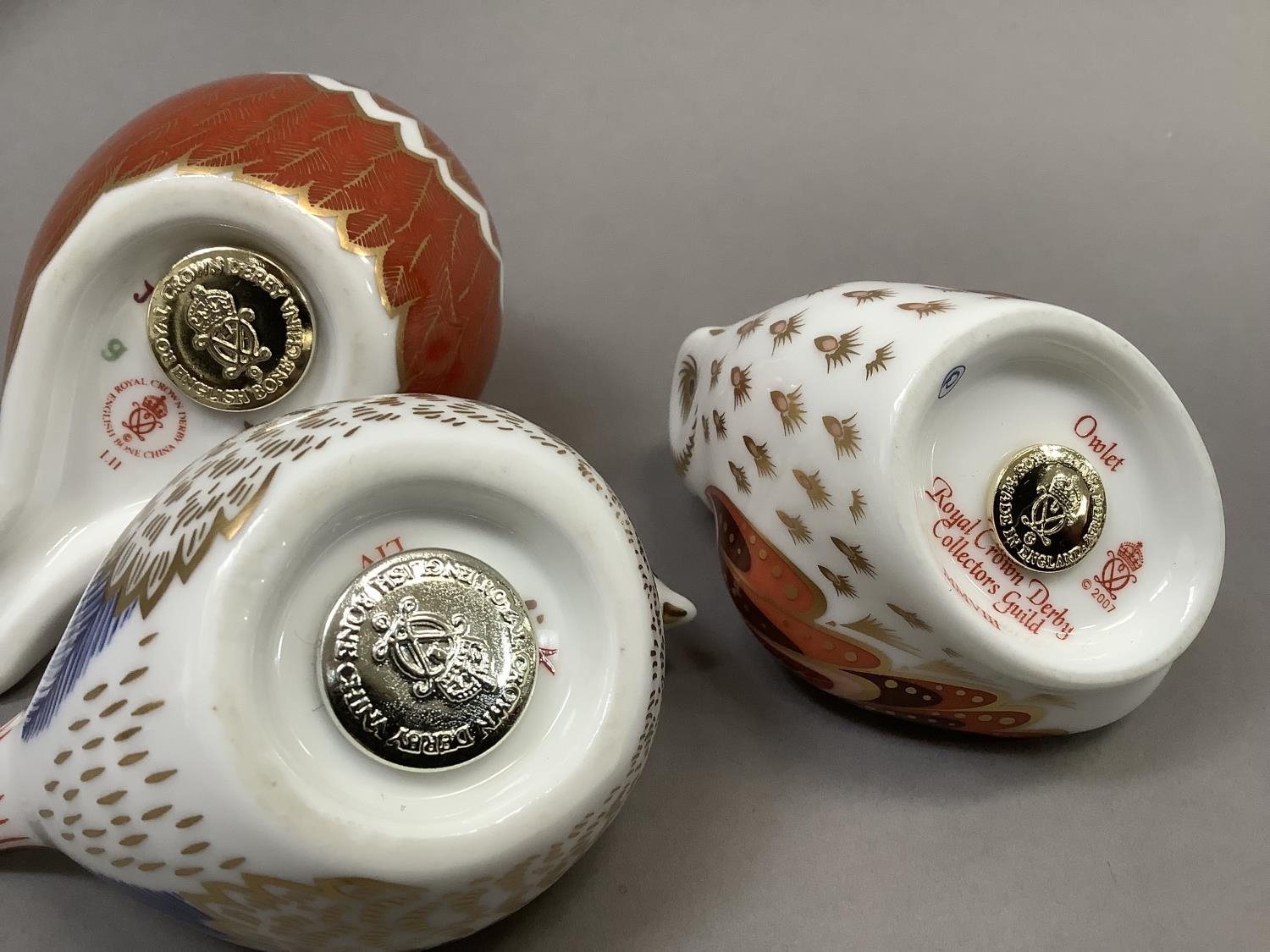 A Royal Crown Derby Collectors Guild owlet paperweight, gilt button, 6cm high together with two - Image 5 of 5