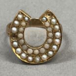 An early 20th century coral and seed pearl set horse shoe ring in 9ct gold (at fault), two pearls