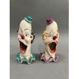 A pair of ceramic clowns heads on ruffled collars with gaping mouths, 15cm high