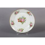 A late 18th century European porcelain plate, polychrome painted with peony and other blossom to the