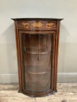 An Edwardian mahogany inlaid and banded bow fronted display cabinet with glazed door and sides (