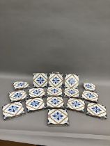 A set of thirteen 19th century Minton tiles glazed in white with a two-shade blue stylised flower to