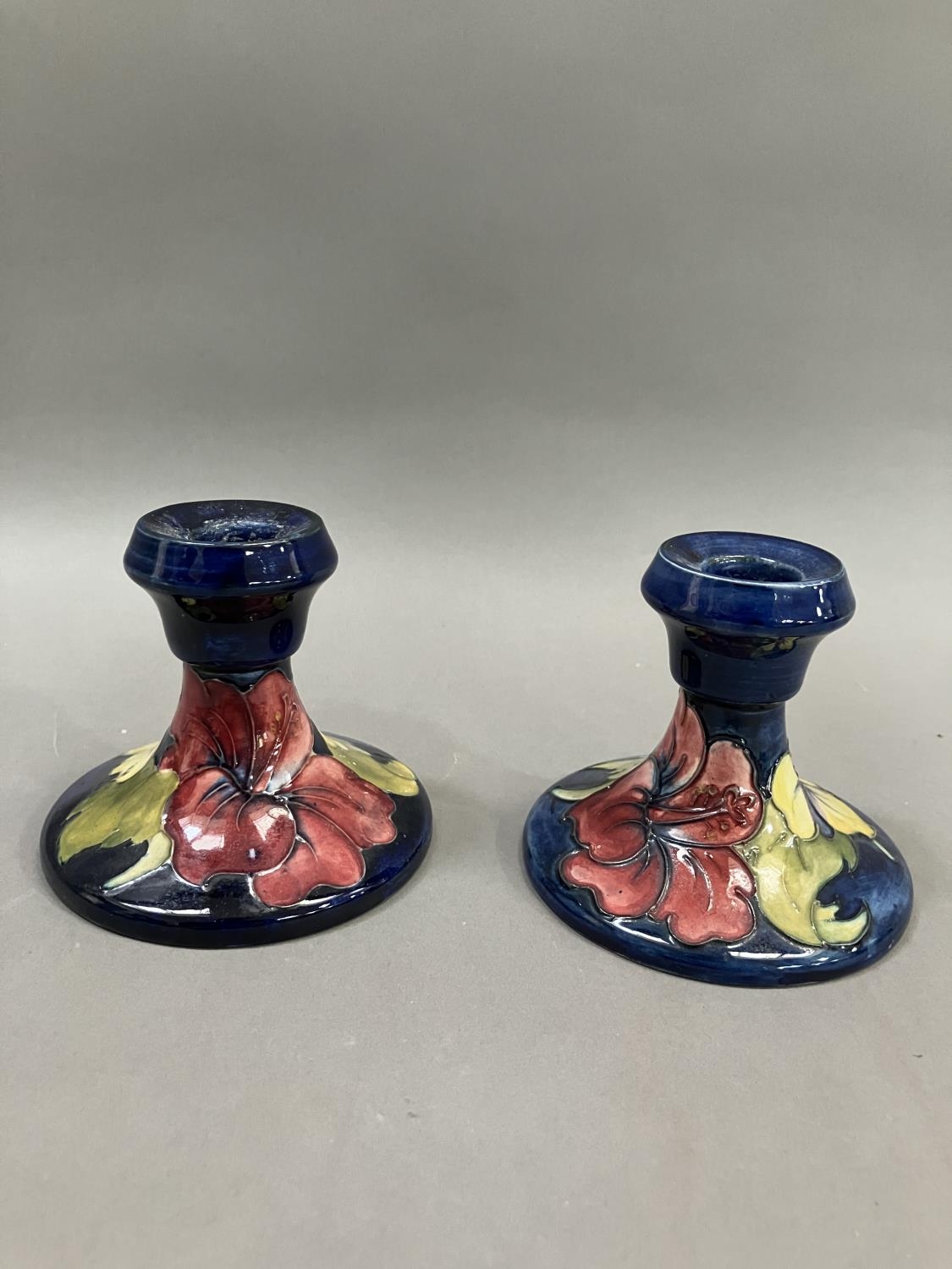 A pair of Moorcroft hibiscus pattern candlesticks, 19cm high - Image 2 of 3