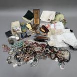 A collection of mid 20th century costume jewellery and early 20th century textiles including