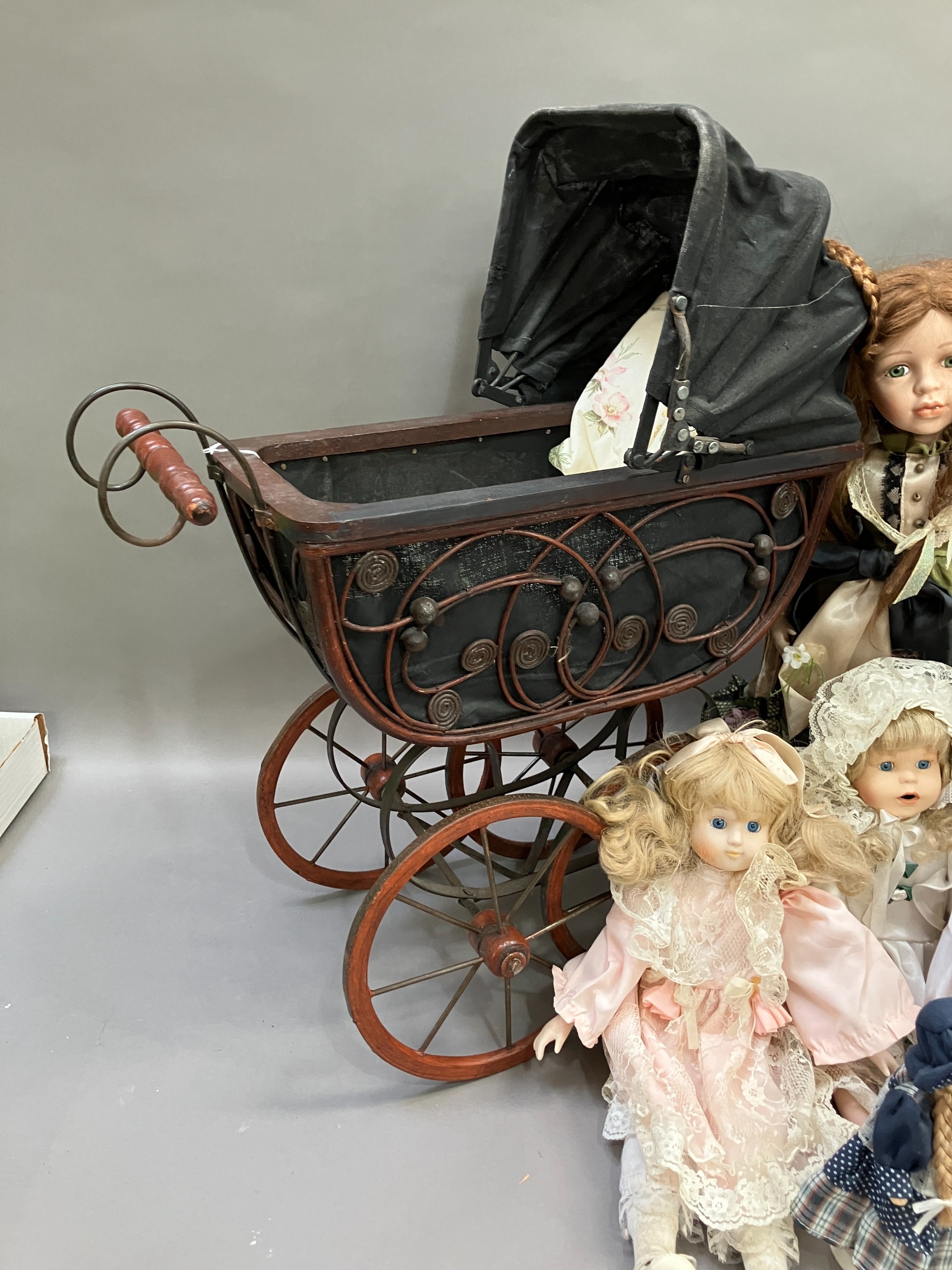 A collection of six modern porcelain dolls in costume, together with two Victorian style prams - Image 3 of 4