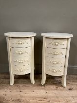 A pair of French style cream painted bedside drawers with circular tops and having four drawers