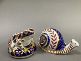 A Royal Crown Derby paperweight snail and a frog with gold button, 7cm and 7.5cm high