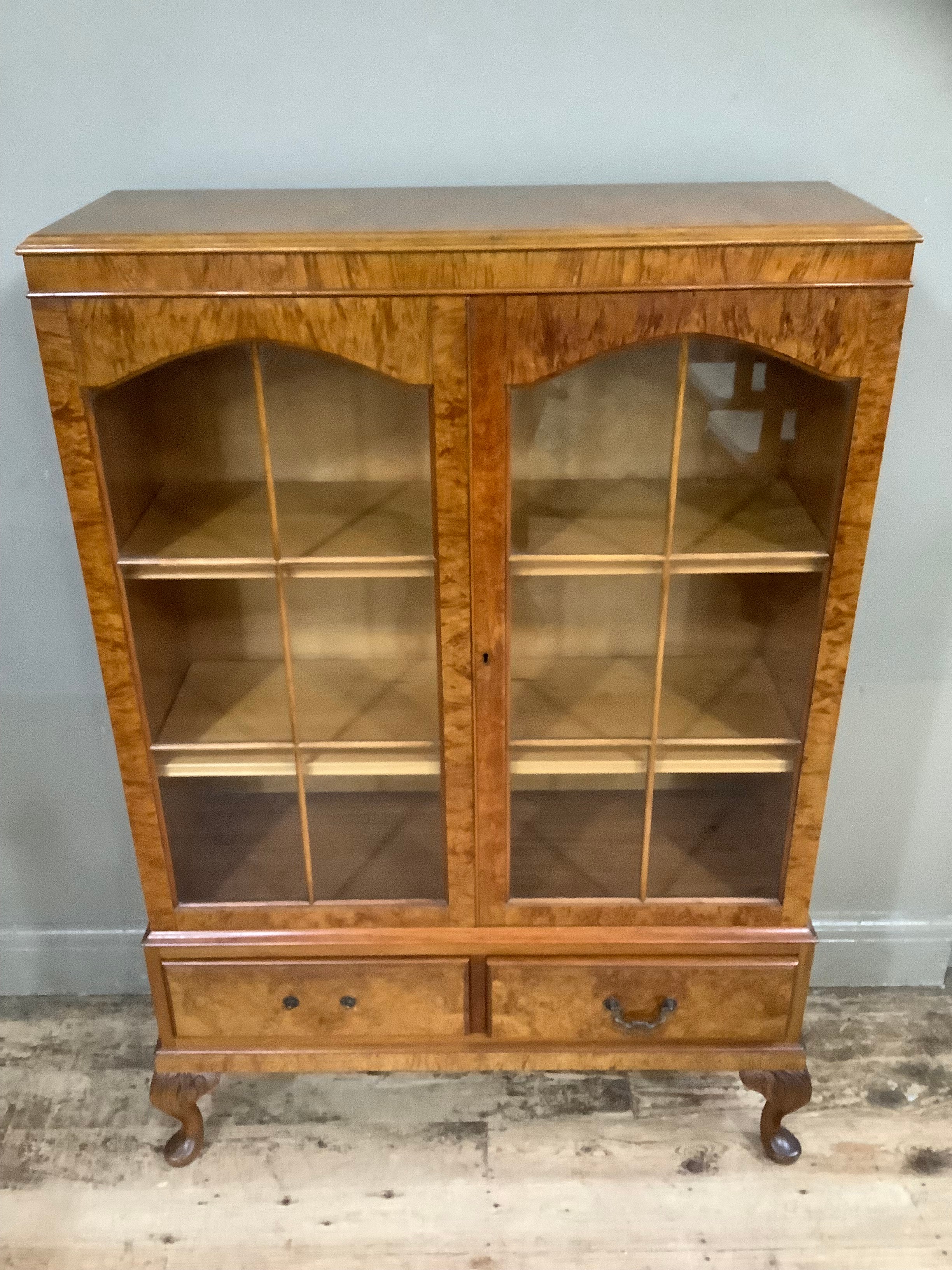 A figured walnut bookcase having two arch profile doors glazed, the interior fitted with adjustable - Image 2 of 3