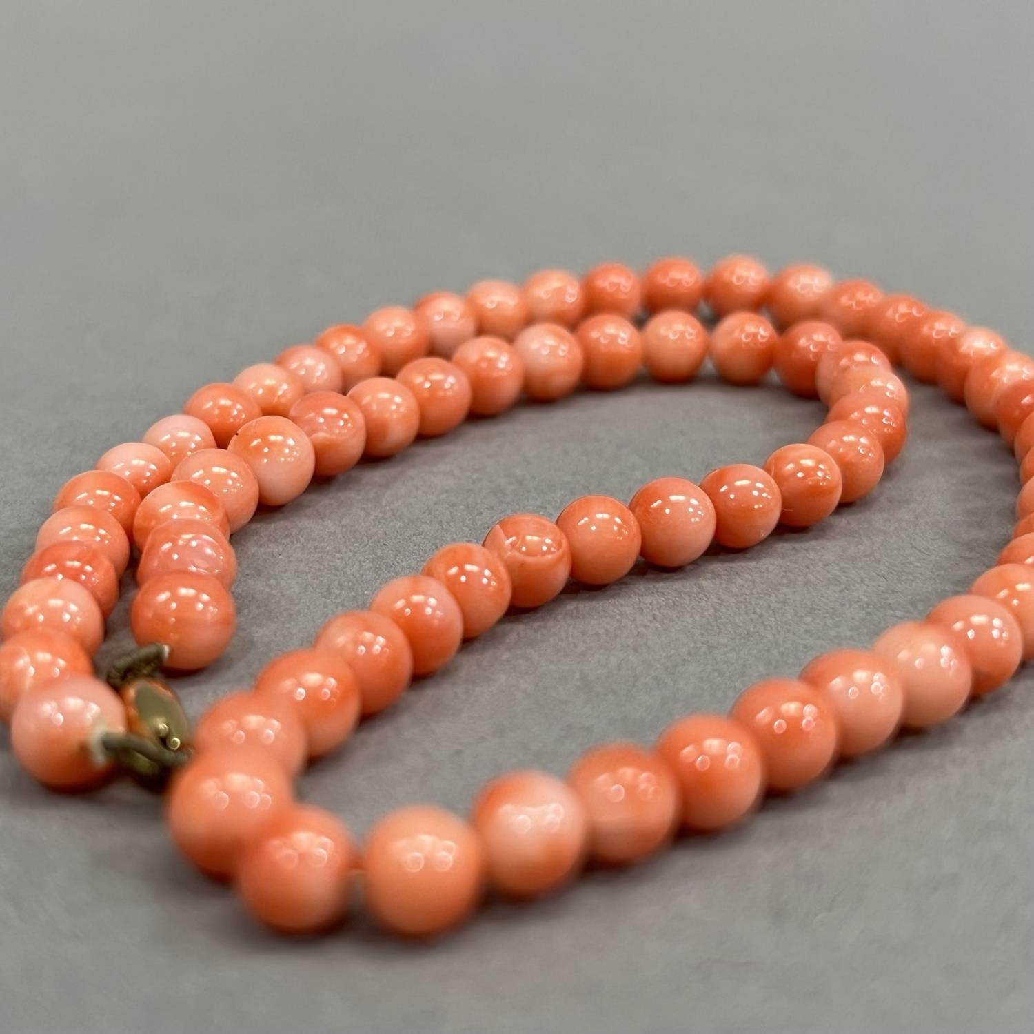 A necklace of spherical coral beads, each approximate 6mm diameter fastened with 9ct gold snap, - Image 3 of 3