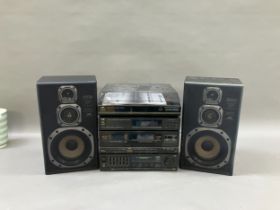 A JVC stereo with double cassette deck, receiver, turntable and two speakers