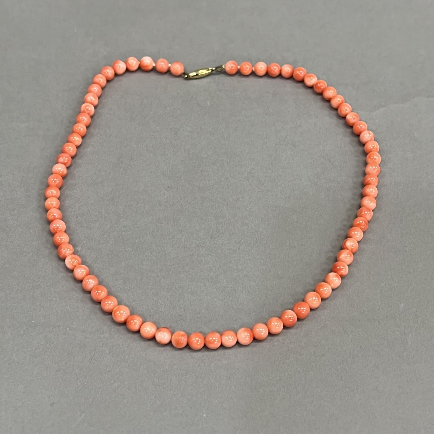 A necklace of spherical coral beads, each approximate 6mm diameter fastened with 9ct gold snap, - Image 2 of 3