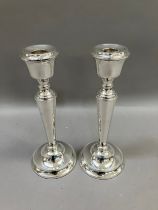 A pair of Elizabeth II silver candlesticks, Birmingham, 1990 for A T Cannon Ltd, tapered stem over a