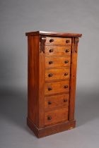 A Mid 19th century mahogany Wellington chest of seven graduated drawers with turned handles, foliate