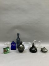 A collection of glassware comprising two oil and vinegar bottles, a tall bottle shaped blue vase,