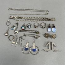 A collection of silver jewellery including a bracelet, earrings, rings and brooches variously set