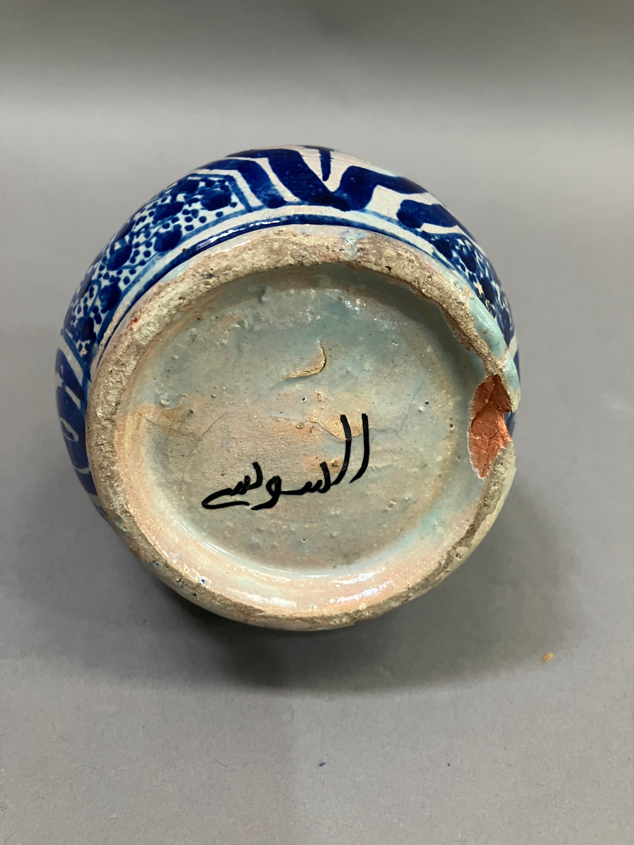 A 19th century Middle Eastern earthenware bottle in grey white and painted in blue with lozenge - Image 3 of 3