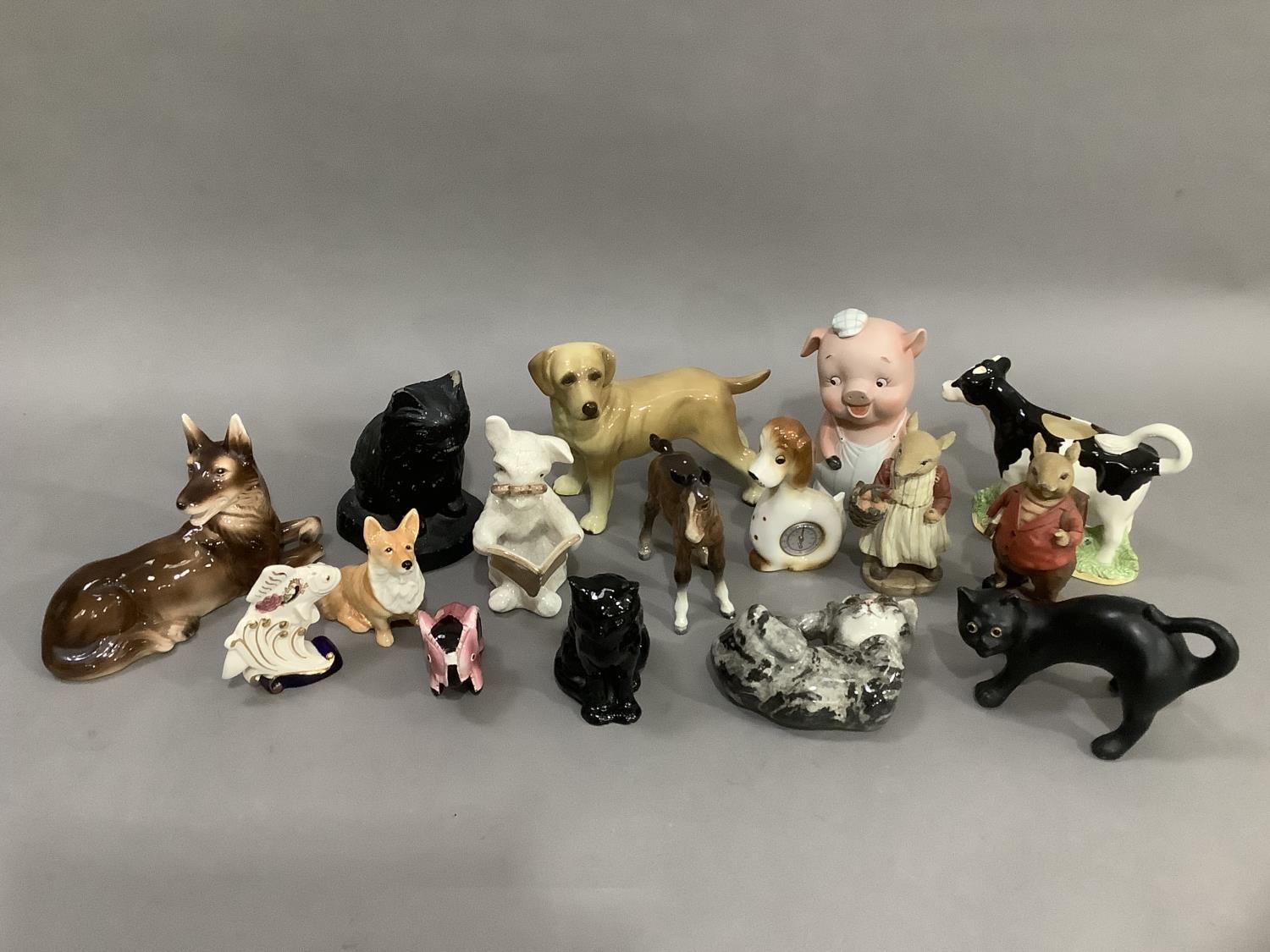 A collection of mainly ceramic animals including dogs, cats, piggy bank, foal, etc