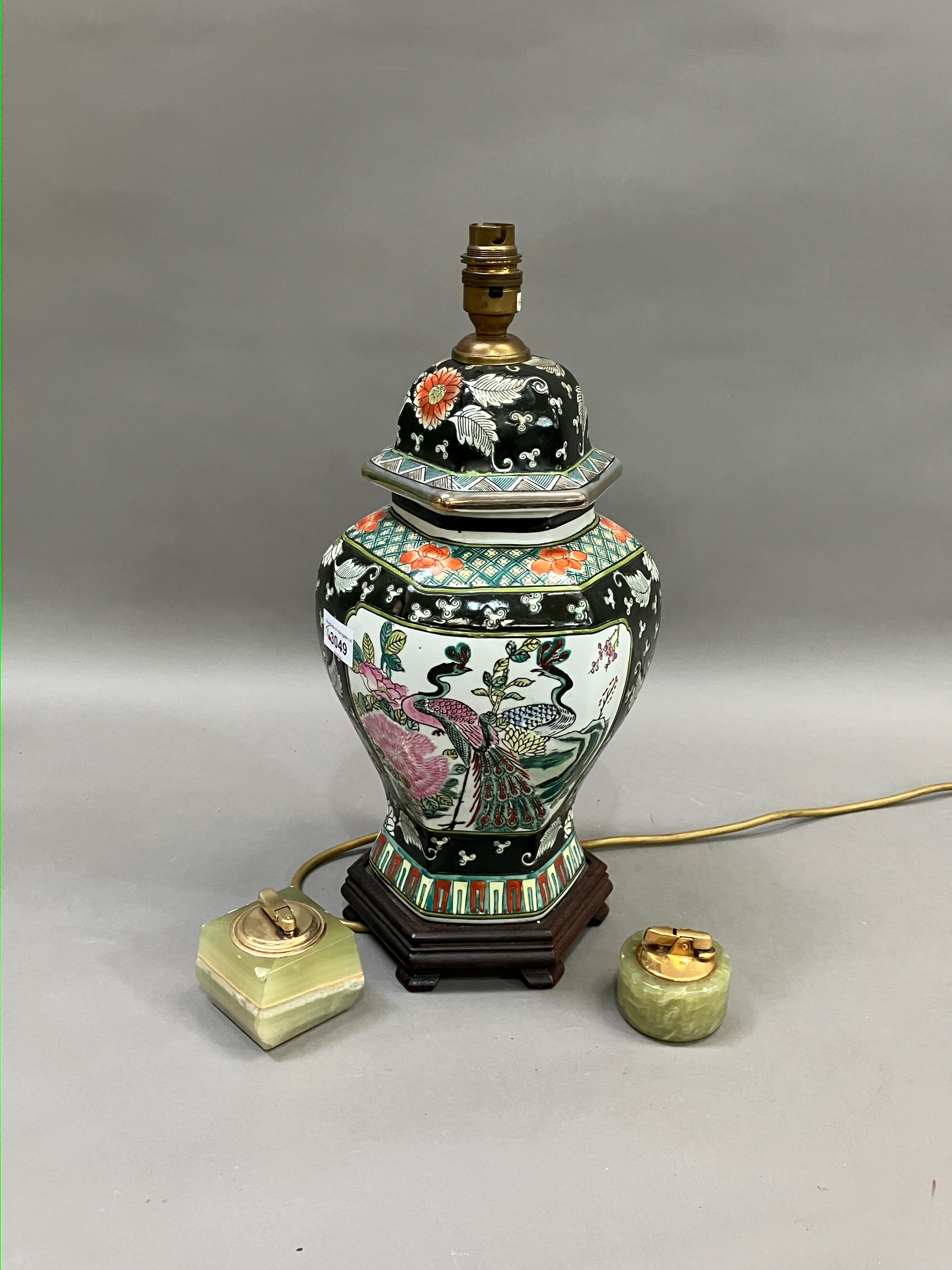 A Chinese famille noir vase and cover converted to a table lamp having peacock filled cartouches,