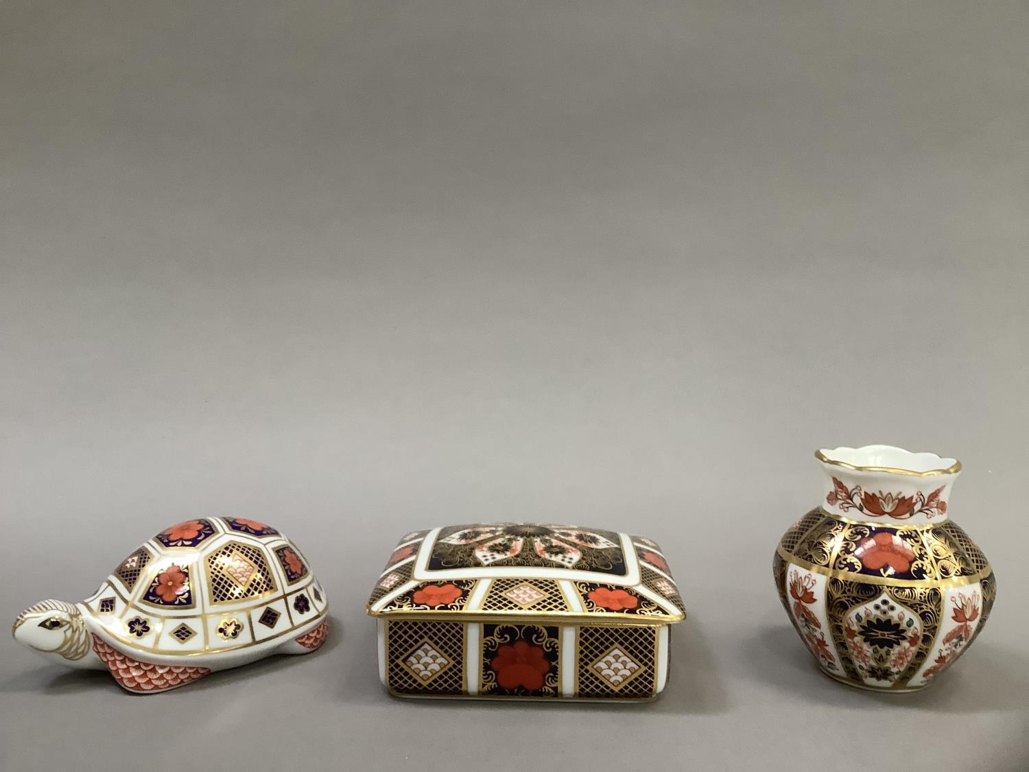 A Royal Crown Derby box and cover, pattern No: 1128, measuring 11cm x 9.5cm x 3.5cm, a vase,