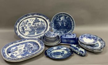 A collection of blue and white ware including 19th century willow pattern plates, later wild rose