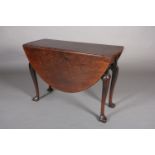 A George III mahogany pembroke dining table, oval, having twin drop leaves, arched apron, on