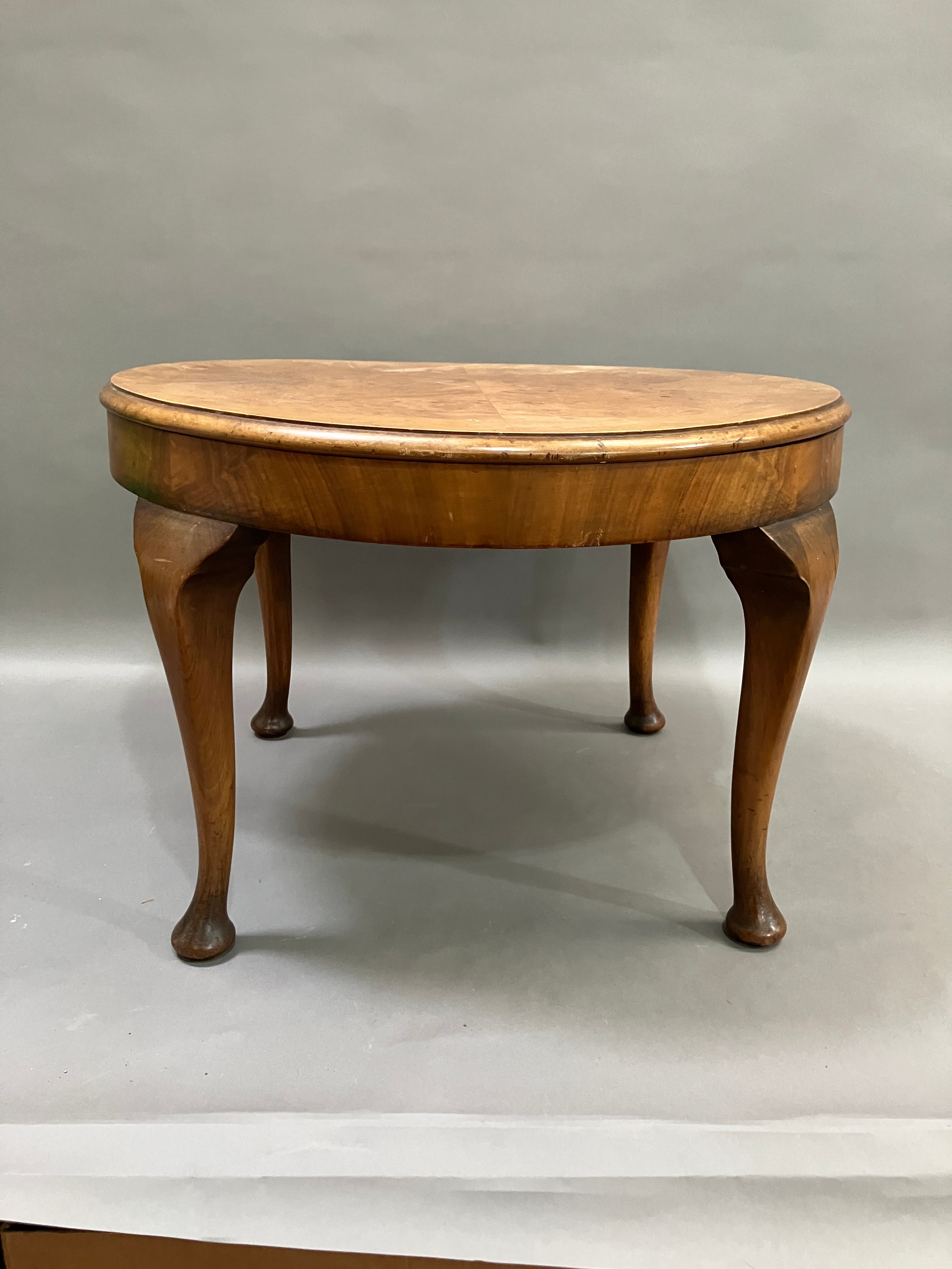 A walnut quarter veneered occasional table on cabriole legs with pad feet, 60cm