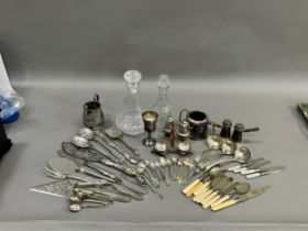 A collection of silver plated ware and glass ware comprising two decanters with stoppers, salt and