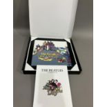 A Coalport Characters Beatles Yellow Submarine plaque, together with a Mad Day Out photoshoot book