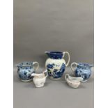A pair of 19th century blue and white transfer printed jugs of floral pattern, 14cm over handle