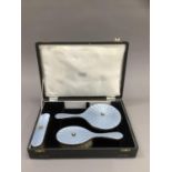 A silver and blue enamel three piece dressing table set, in fitted case,