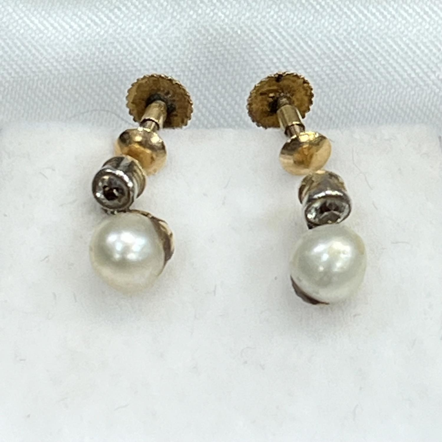 A pair of cultured pearl and diamond earrings, c1920, in 9ct gold, each 5.5mm pearl pendant from a - Image 2 of 2