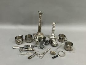 A moulded silver plate on copper candlestick, another silver plate candlestick, two pairs of