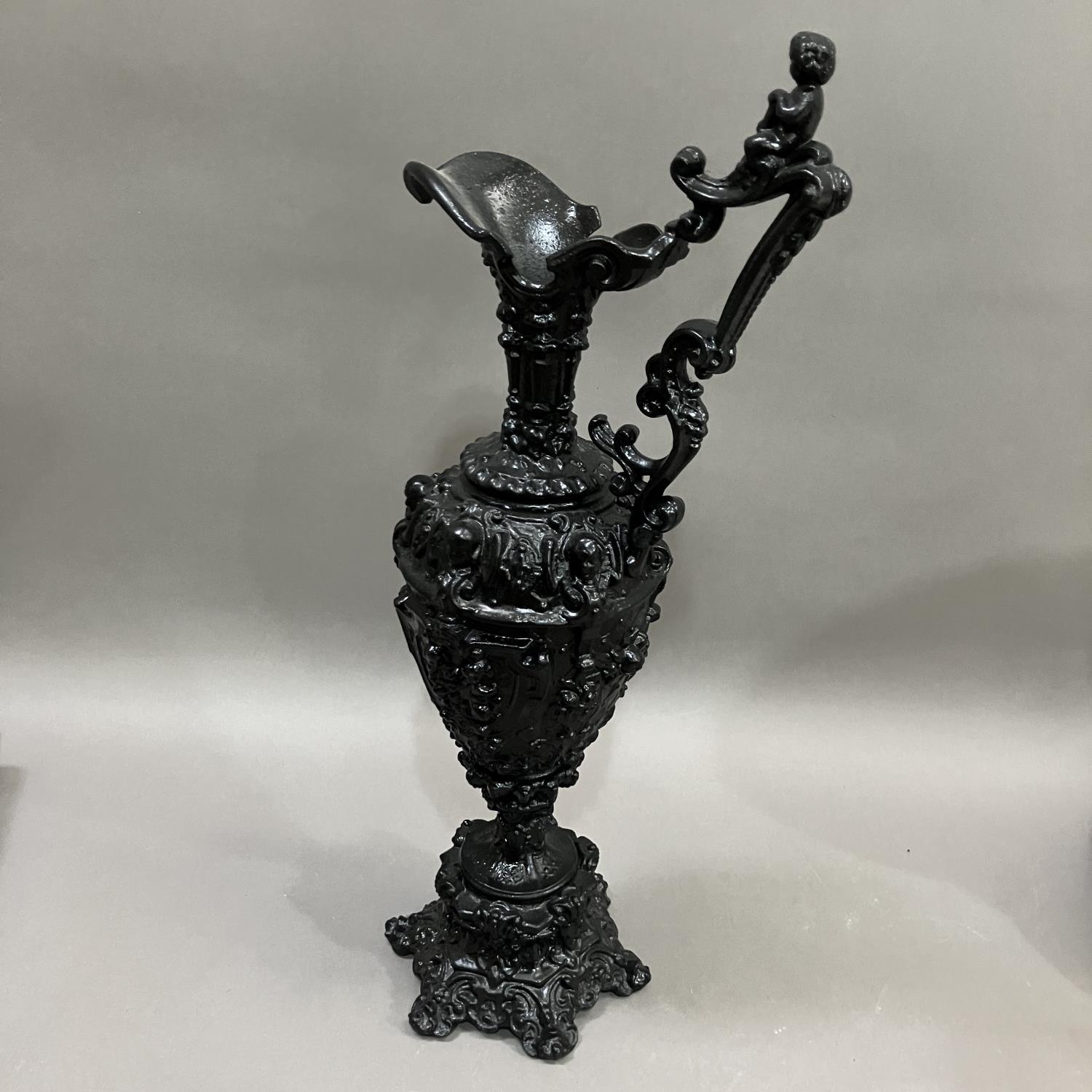 A French black cast metal and heavily moulded ewer, the handle surmounted by cherub, 45cm high - Image 5 of 5