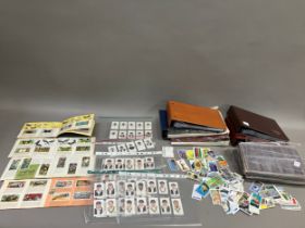 Five cigarette card albums and a quantity of sleeves (empty), four trade card albums and a small