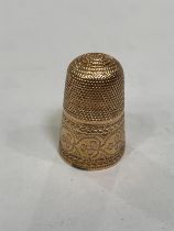 A late 18th/early 19th century thimble in 15ct rose gold, with hammered foliate band and with open