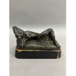 A cast bronze model of a nude woman reclining, indistinctly signed on base 26cm long