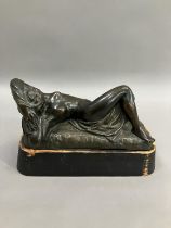 A cast bronze model of a nude woman reclining, indistinctly signed on base 26cm long