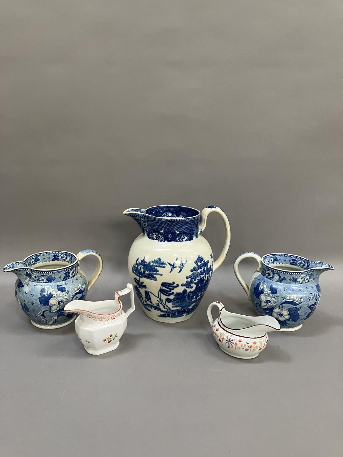 A pair of 19th century blue and white transfer printed jugs of floral pattern, 14cm over handle - Image 3 of 7