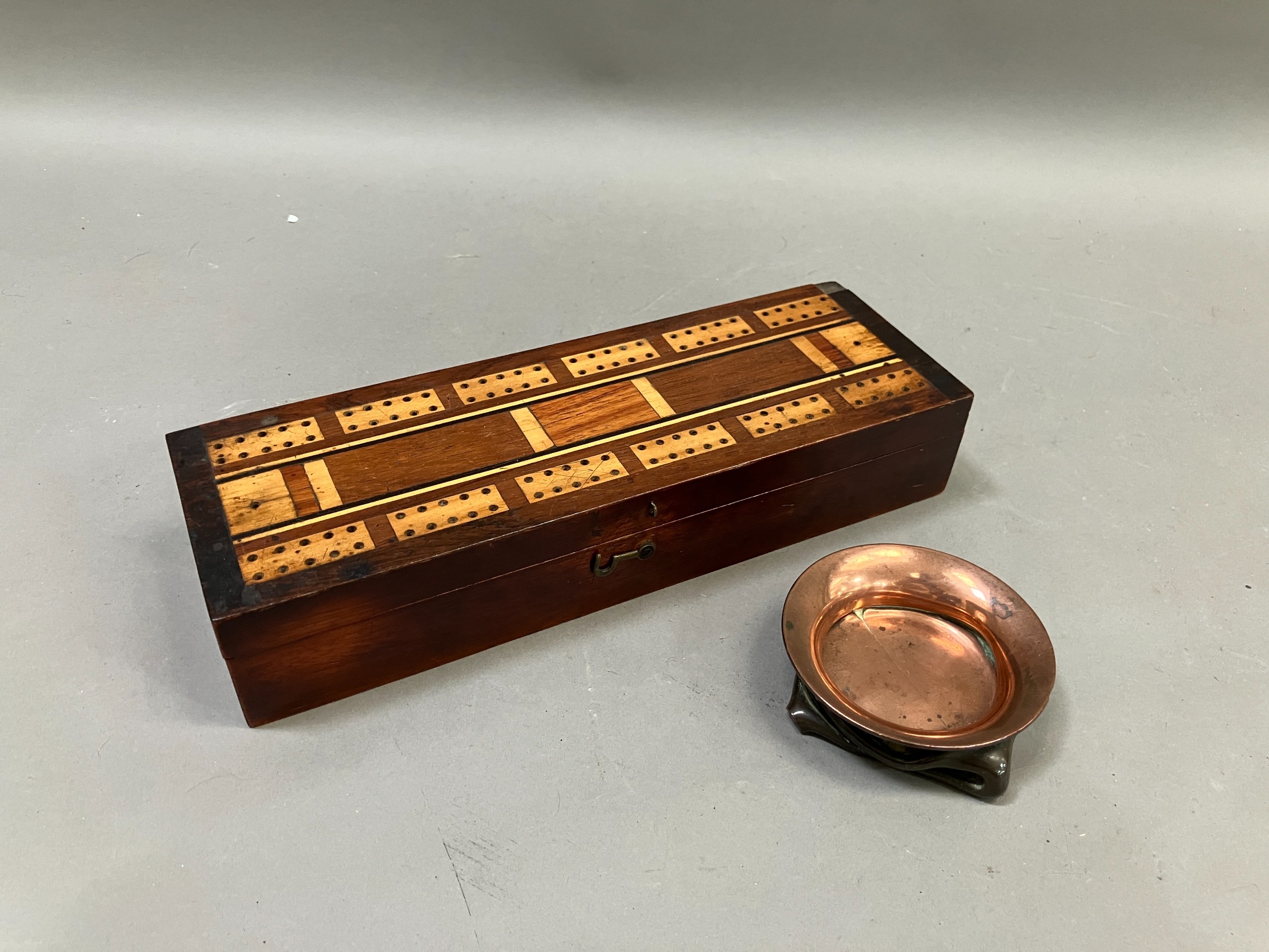 An early 20th century games box with inlaid cover, interior with four whist markers together with