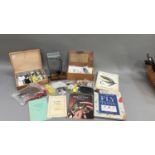 Fishing: two boxes of fly tying equipment, a fly tying vice, five fly tying books