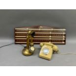 Two vintage telephones and a scoreboard