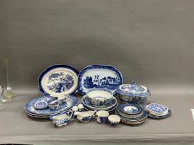 A 19th century lidded willow pattern blue and white tureen with finial, together with other blue and